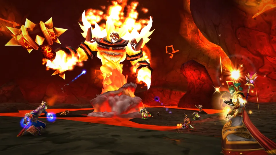 A raid group of mages, priests and warriors fights the fire giant Ragnaros in a lava cavern in Molten Core.