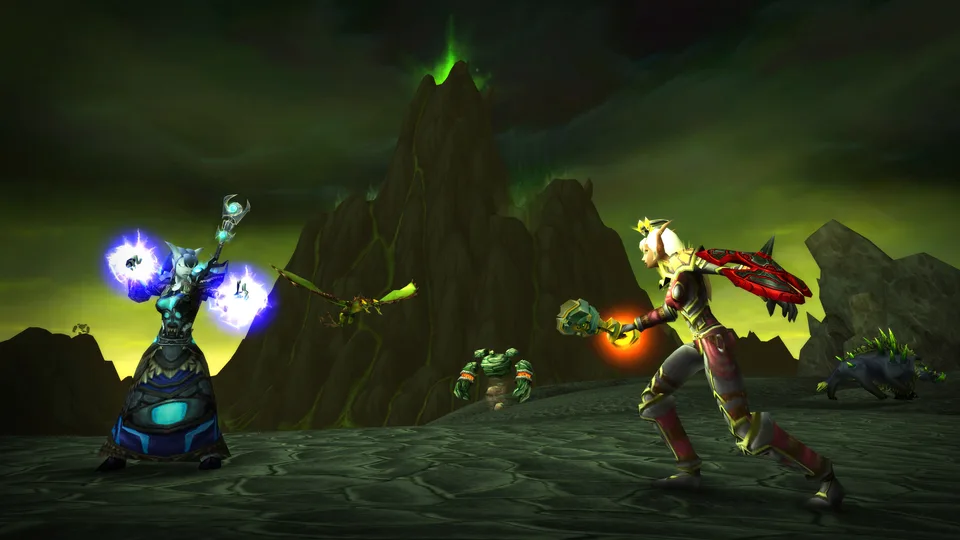 A blood elf and a draenei caster cast spells in front of a green-skied Outland mountain while creatures approach.