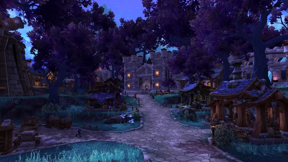 An Alliance garrison village at night with a cobbled street, buildings and one character.